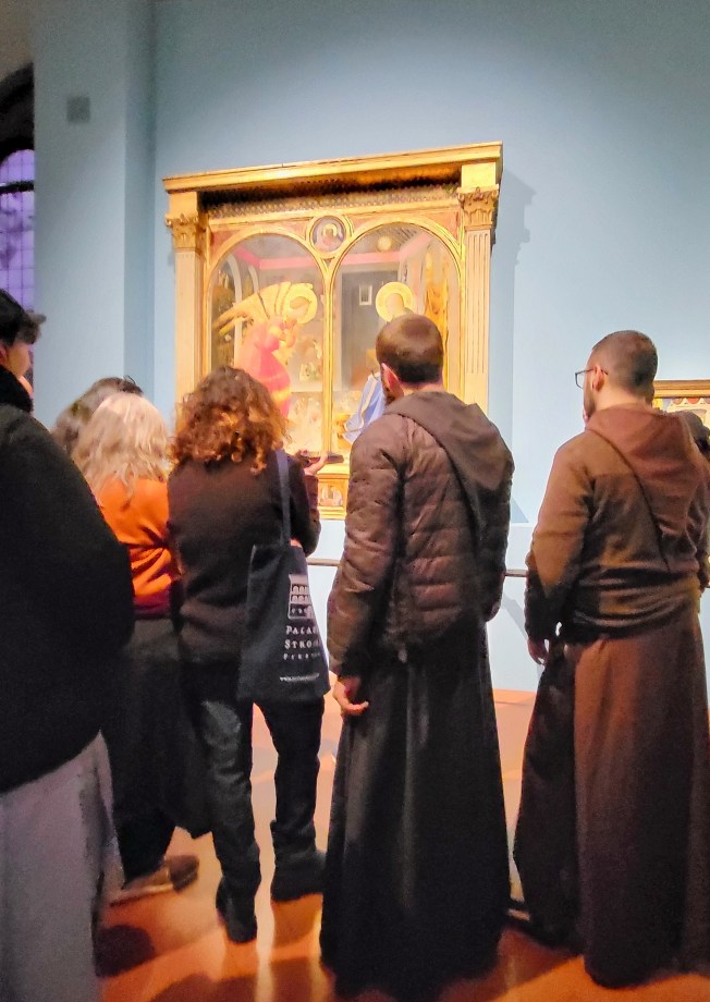 Lots of people enjoying the exhibit, including these monks